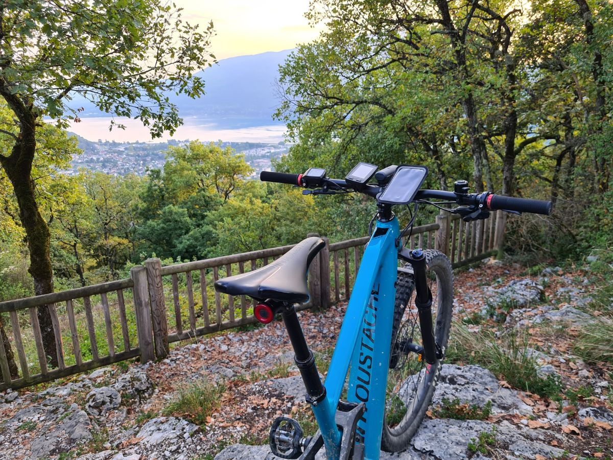 Ciclista che consulta una mappa sul suo GPS dedicato e un altro su un'app mobile.