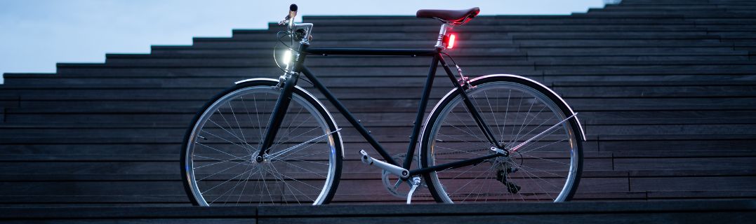Bici equipaggiata con le luci magnetiche Shapeheart di notte, visibilità ottimale con illuminazione anteriore bianca e posteriore rossa